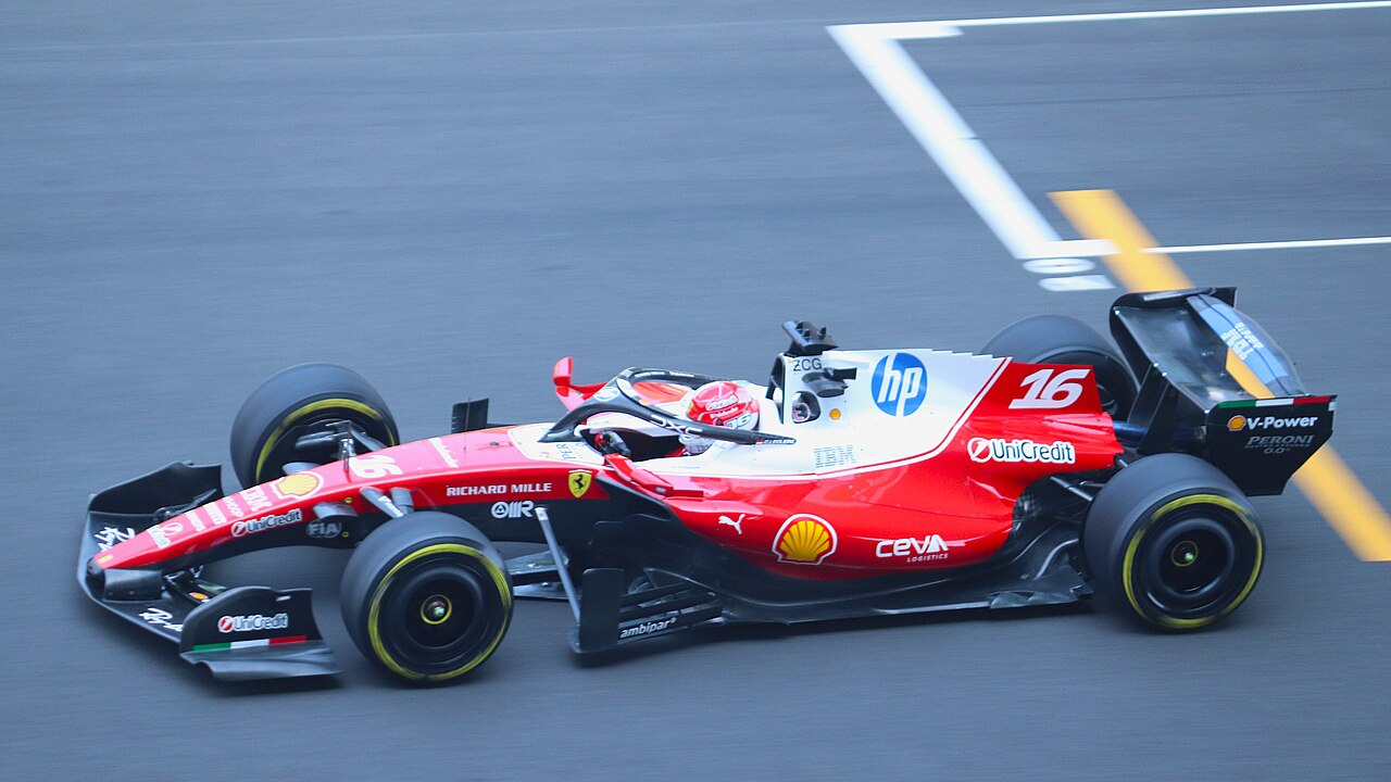 Charles Leclerc's red Ferrari F1 car at speed on track during a practice session