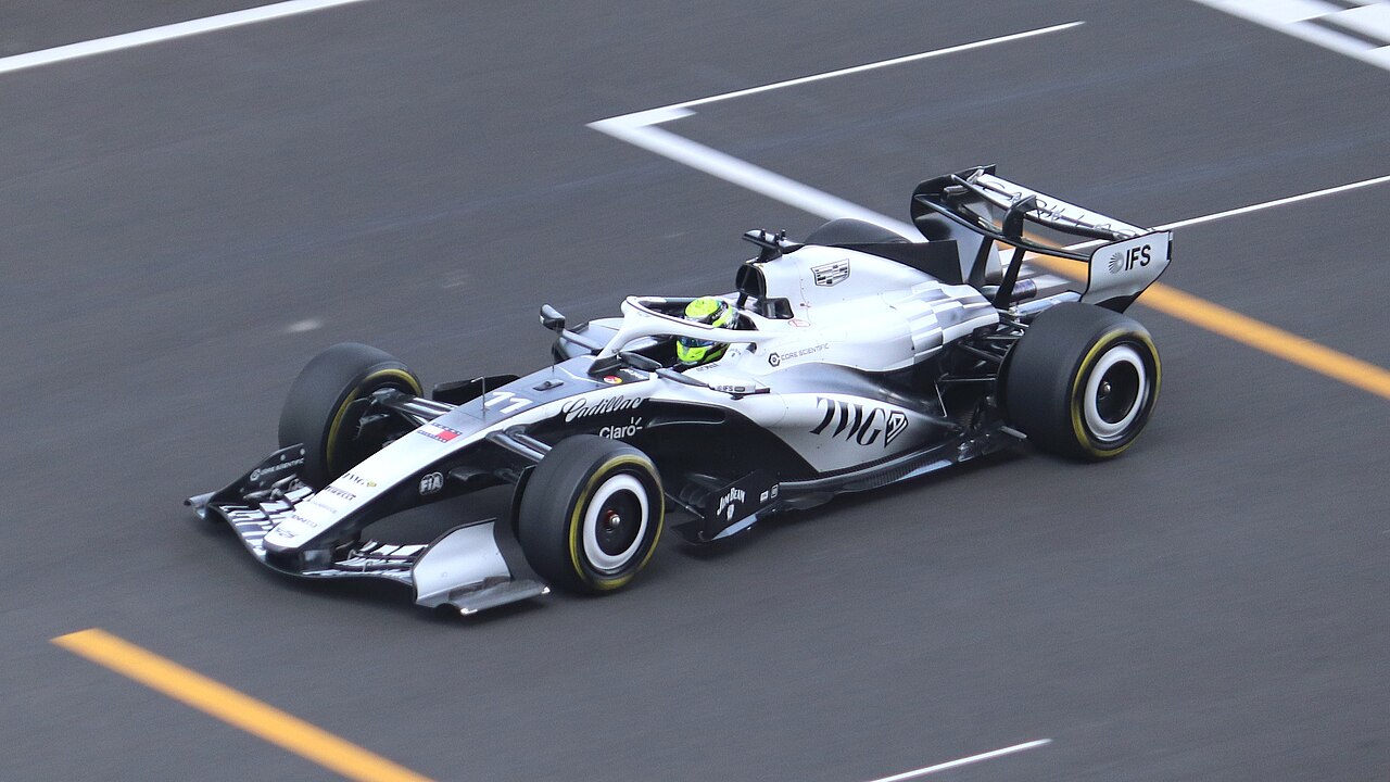 Sergio Perez's white and black Cadillac on a grey track with yellow and white lines