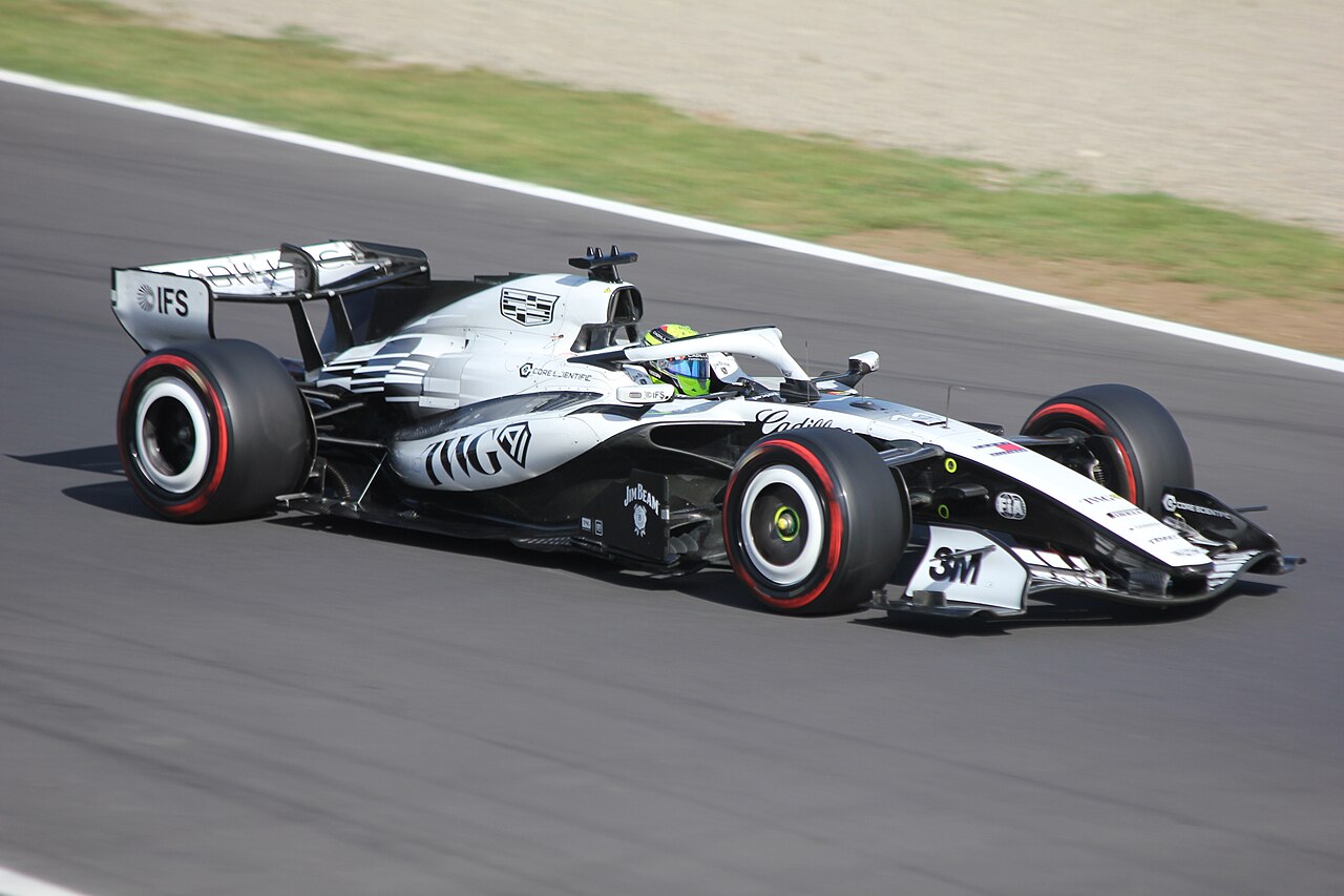 Sergio Perez driving his white and black car on track at Monza